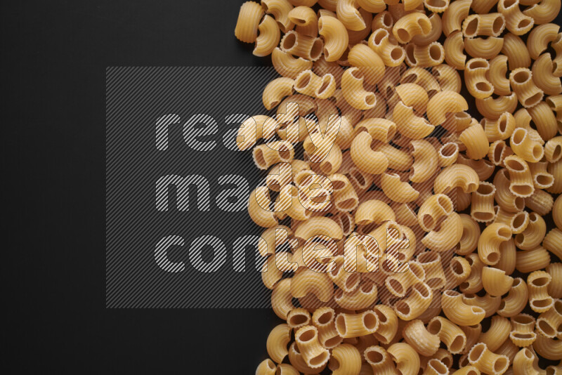 Different pasta types on black background