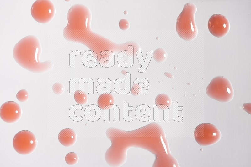 Close-ups of abstract red paint droplets on white background