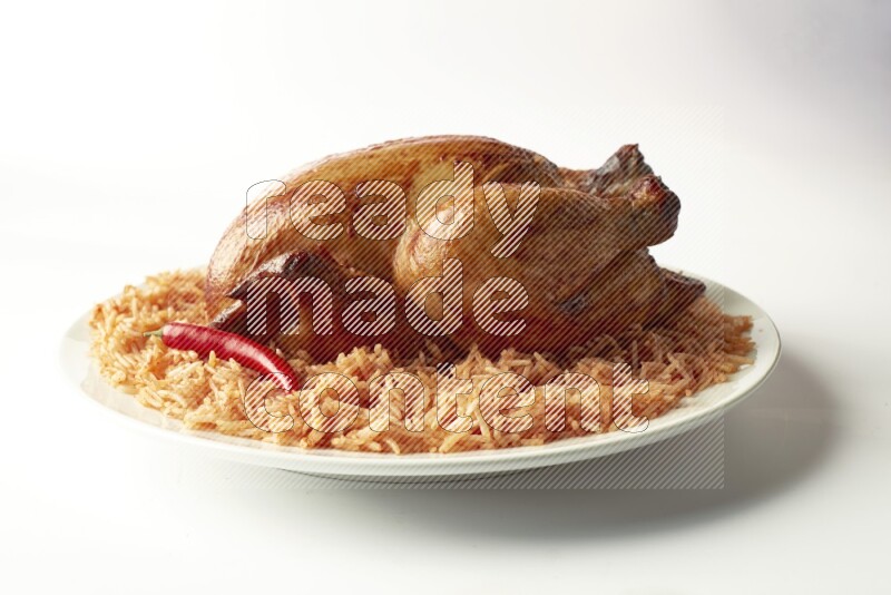 red basmati Rice with  whole roasted chicken on a white rounded plate  direct  on white background