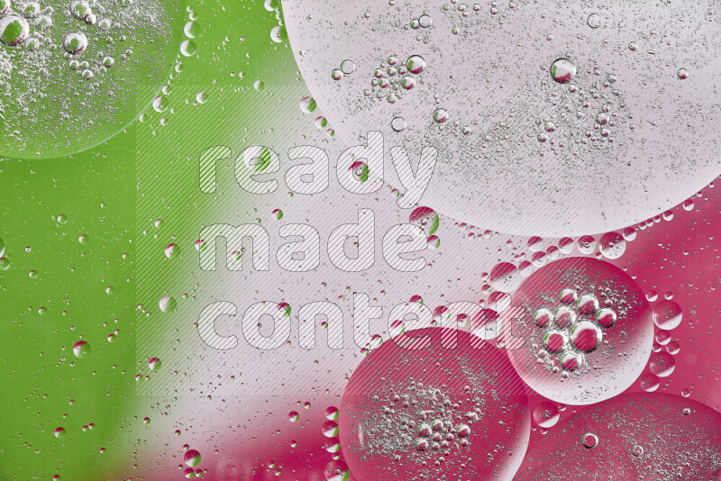 Close-ups of abstract oil bubbles on water surface in shades of pink, green and white