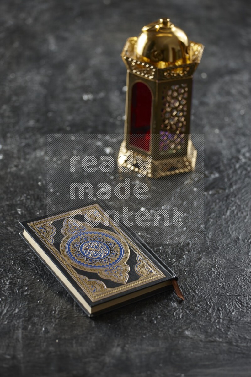 A golden lantern with different drinks, dates, nuts, prayer beads and quran on textured black background