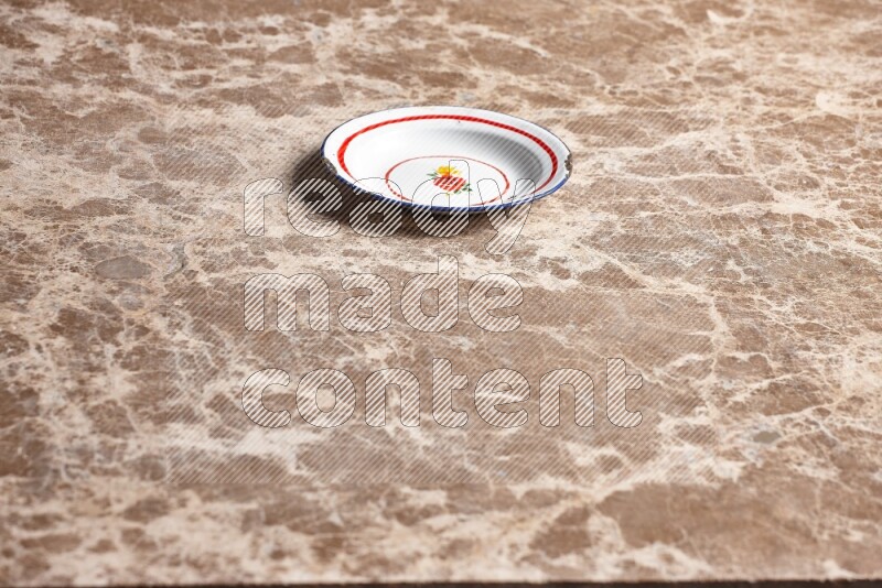 A vintage metal plate on beige marble background