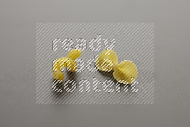 Twist pasta with other types of pasta on grey background