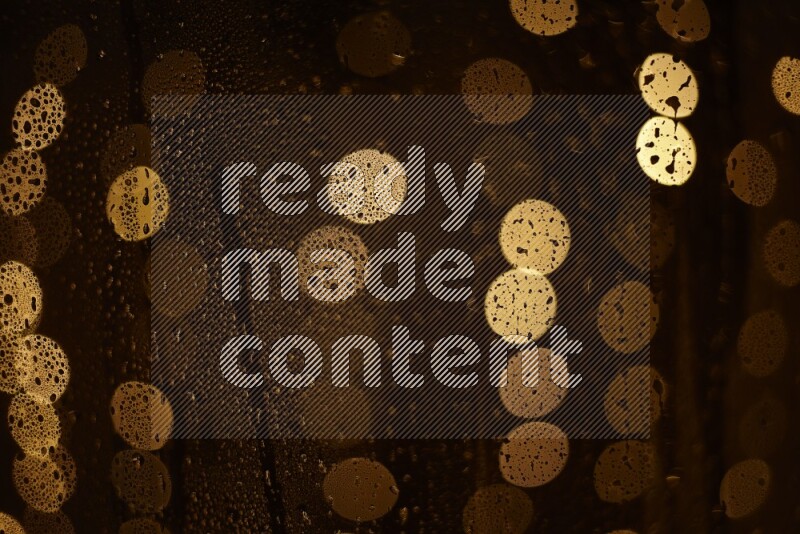 Bokeh light in yellow with water drops