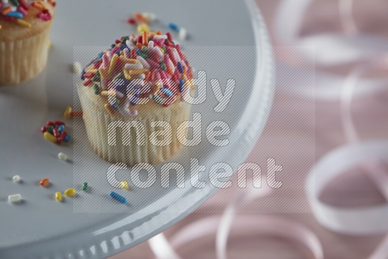 Vanilla mini cupcake topped with sprinkles