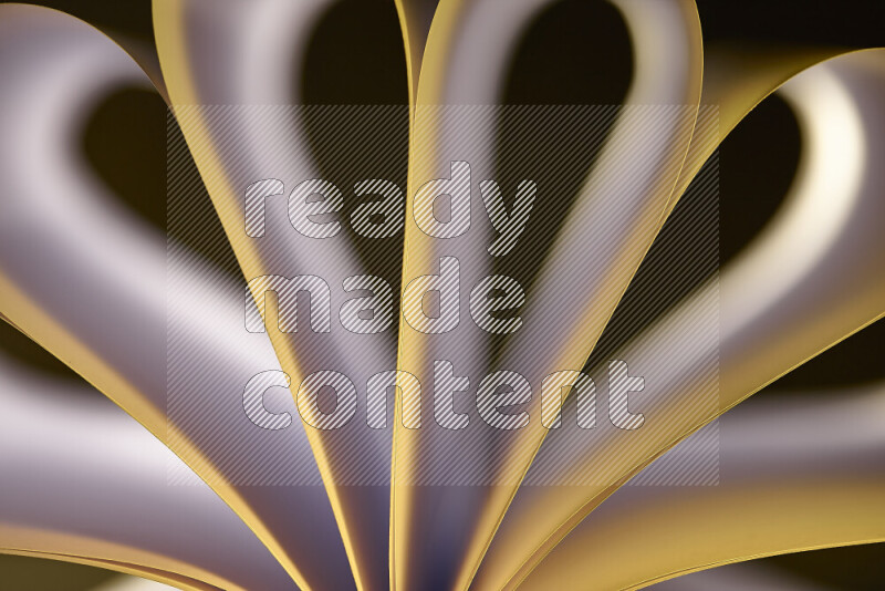 An abstract art piece displaying smooth curves in white and yellow gradients created by colored light