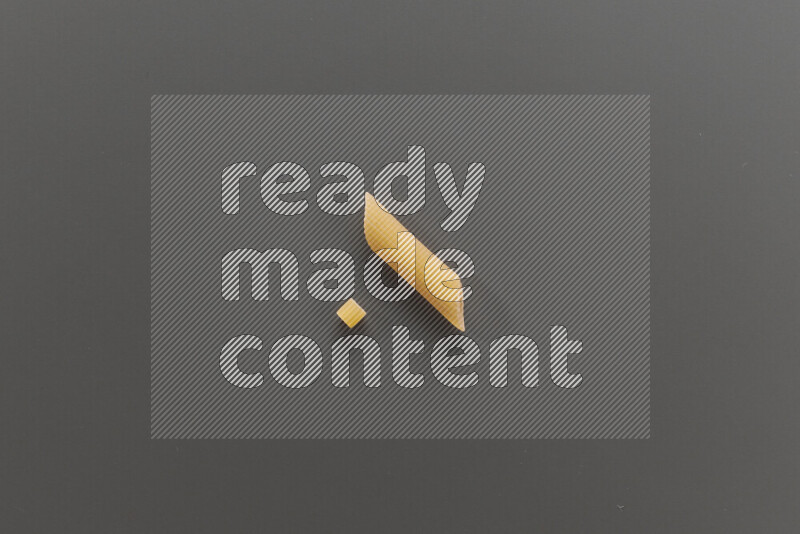 Small rings pasta with other types of pasta on grey background