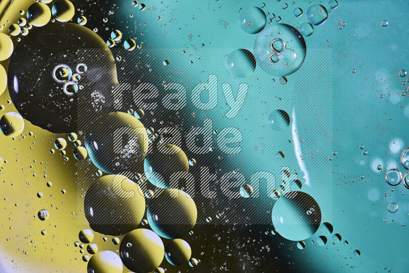 Close-ups of abstract oil bubbles on water surface in shades of green, black and yellow