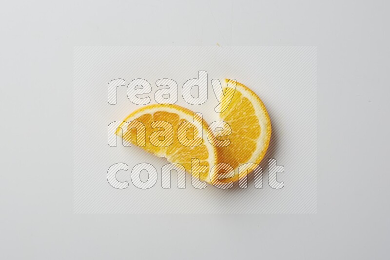 Two halves of an orange slices on white background