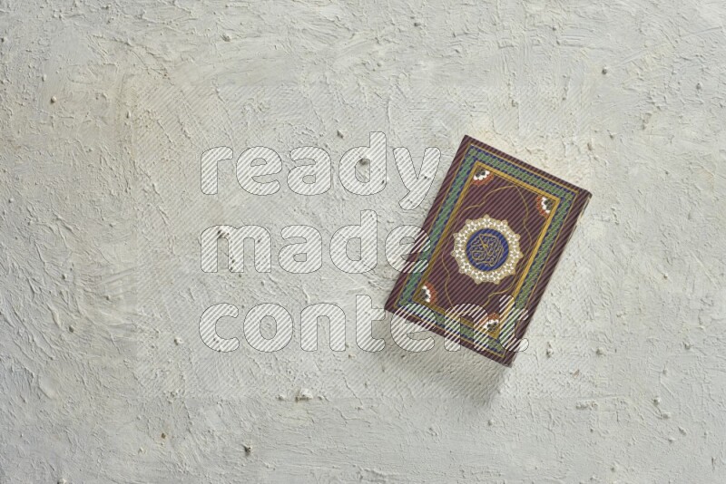 Quran with a prayer beads on white background