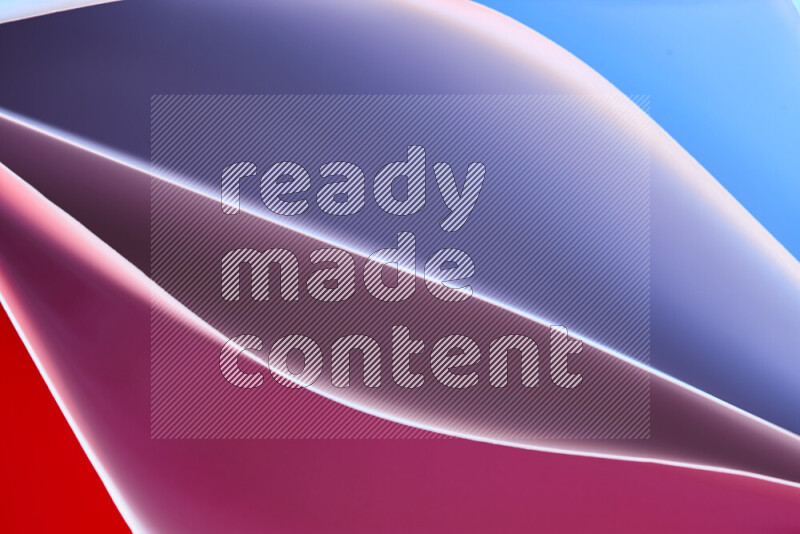 This image showcases an abstract paper art composition with paper curves in blue, purple and red gradients created by colored light