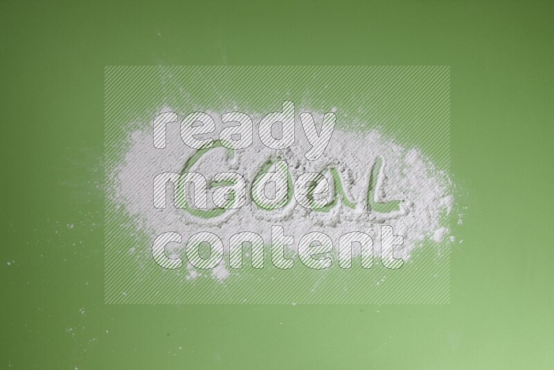 A word written with white powder on green background