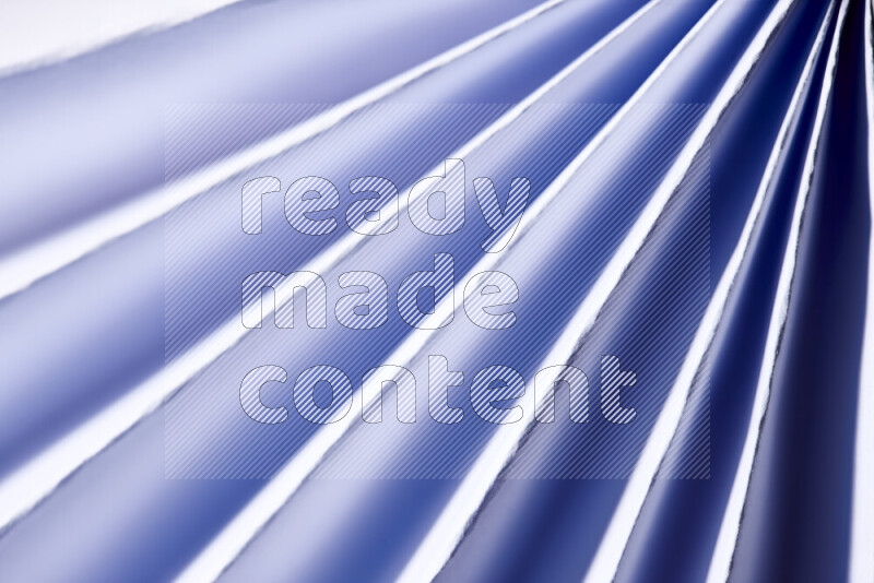 An image presenting an abstract paper pattern of lines in blue and white tones