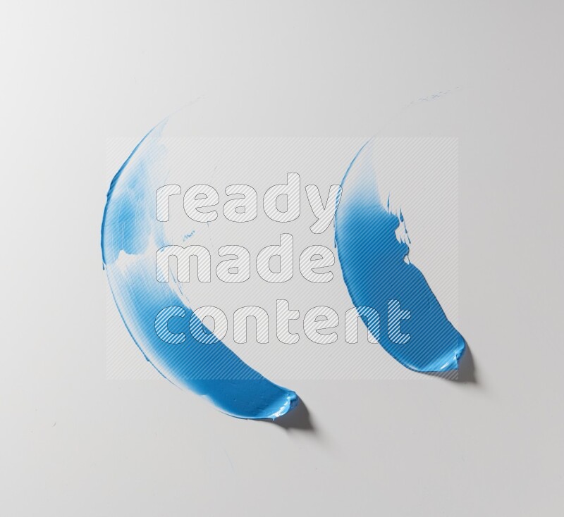 Blue curved painting knife strokes on white background