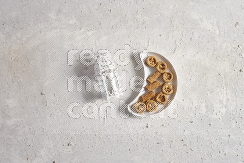 Oriental sweets in a pottery plate with lantern in a light setup