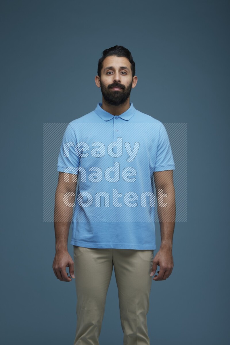 Man posing in a blue background wearing a Blue shirt