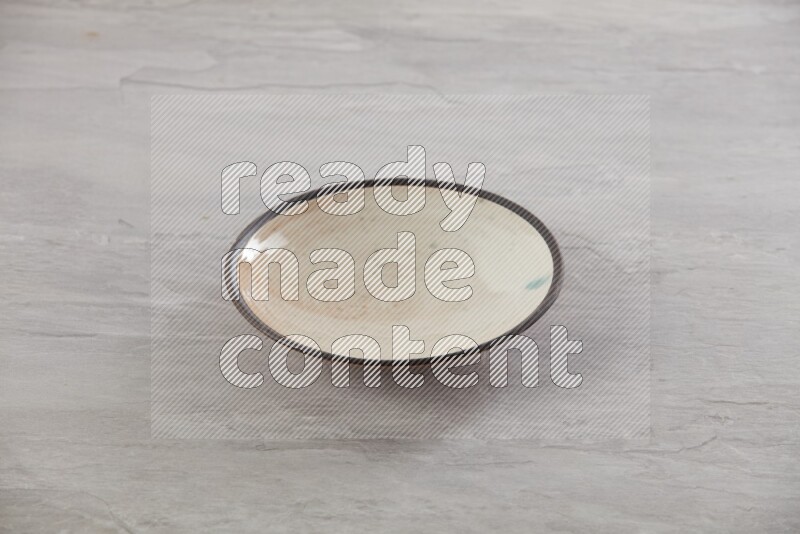multi color ceramic round plate on grey textured countertop