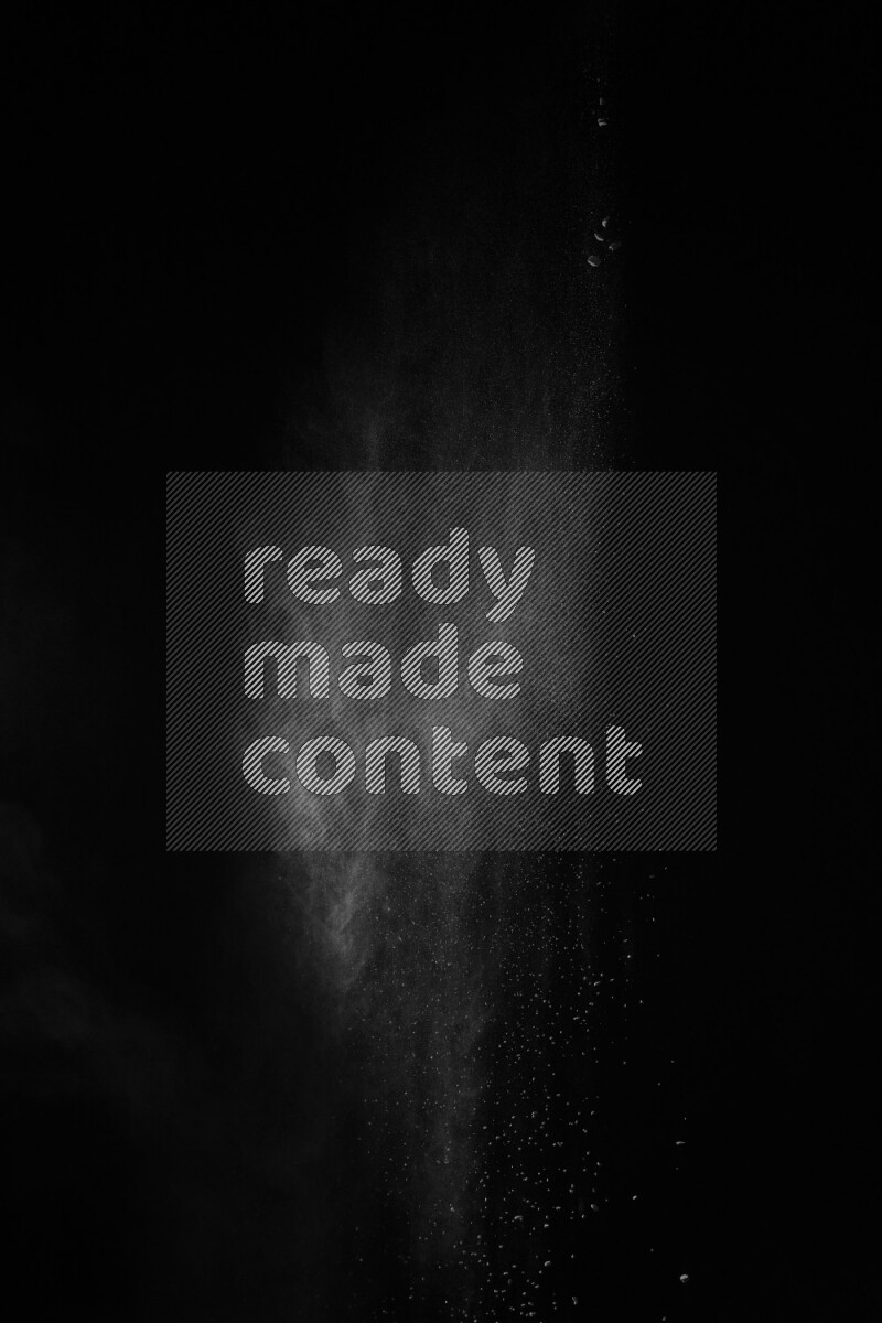 A side view of white powder explosion on black background