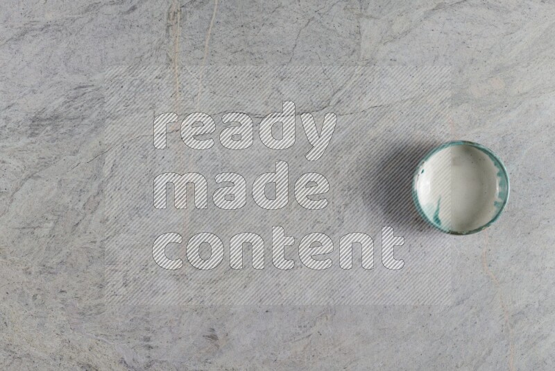 A multicolored pottery Bowl on grey marble background