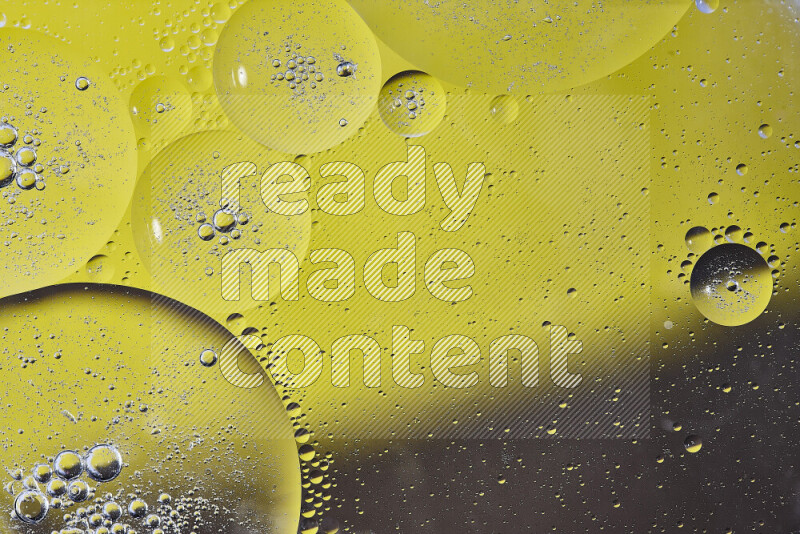Close-ups of abstract oil bubbles on water surface in shades of yellow and brown
