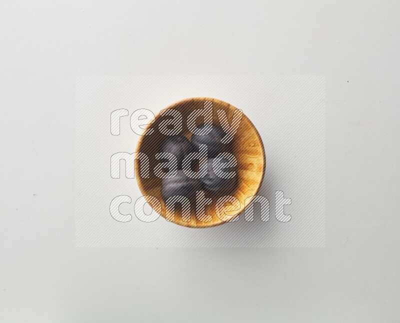 Top-view shot of dried lime (loomi) in a container on white background