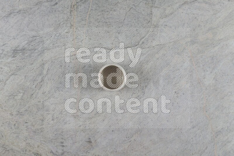 A multicolored pottery Cup on grey marble background