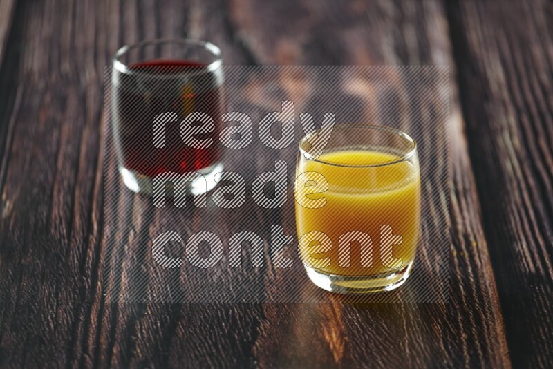 Cold drinks in a glass cup such as water, tamarind, qamar eldin, sobia, milk and hibiscus on wooden background