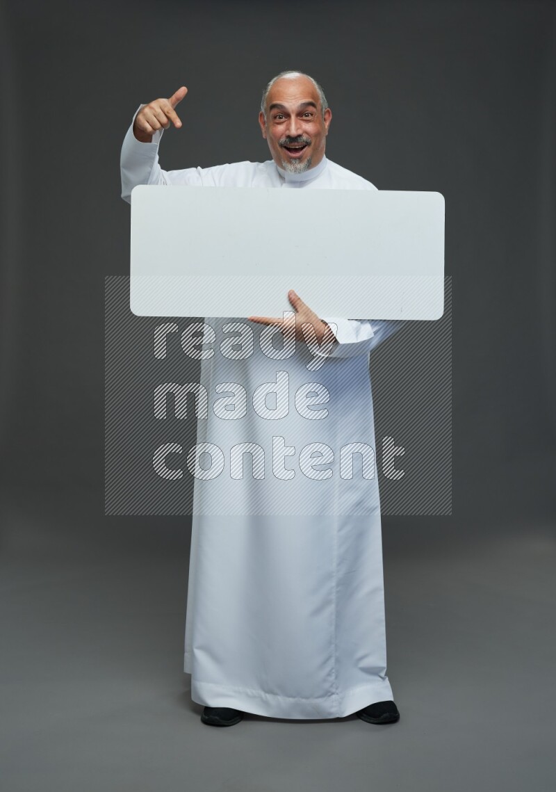 Saudi man without shomag Standing holding social media sing on gray background