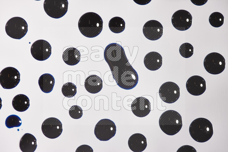 Close-ups of abstract blue paint droplets on the surface