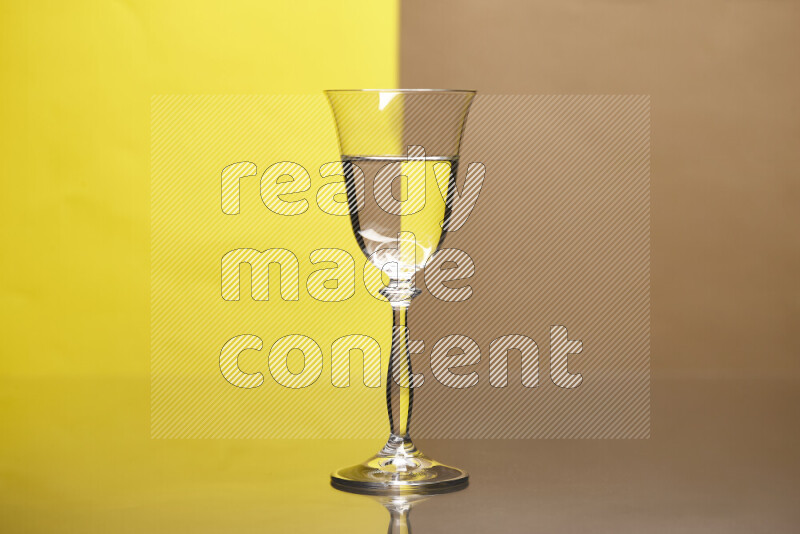 The image features a clear glassware filled with water, set against yellow and beige background