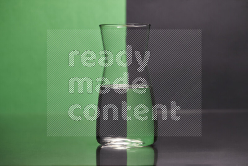The image features a clear glassware filled with water, set against green and black background