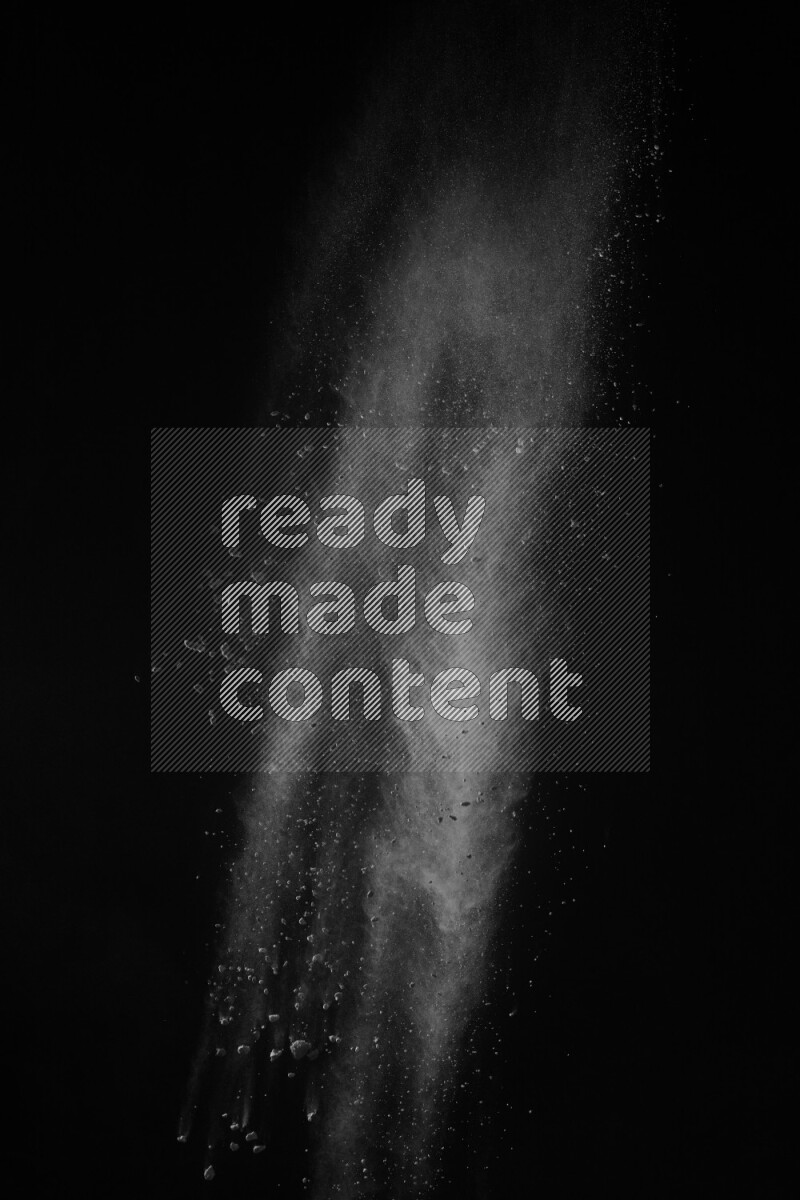 A side view of white powder explosion on black background