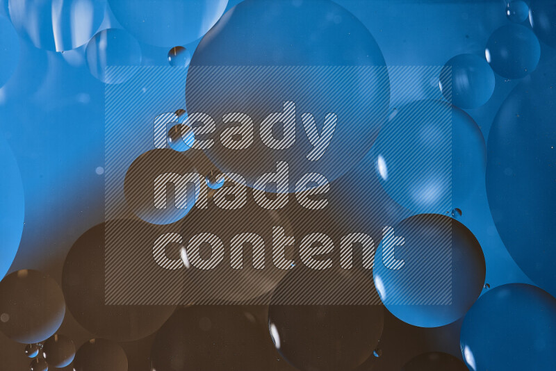 Close-ups of abstract oil bubbles on water surface in shades of blue and brown