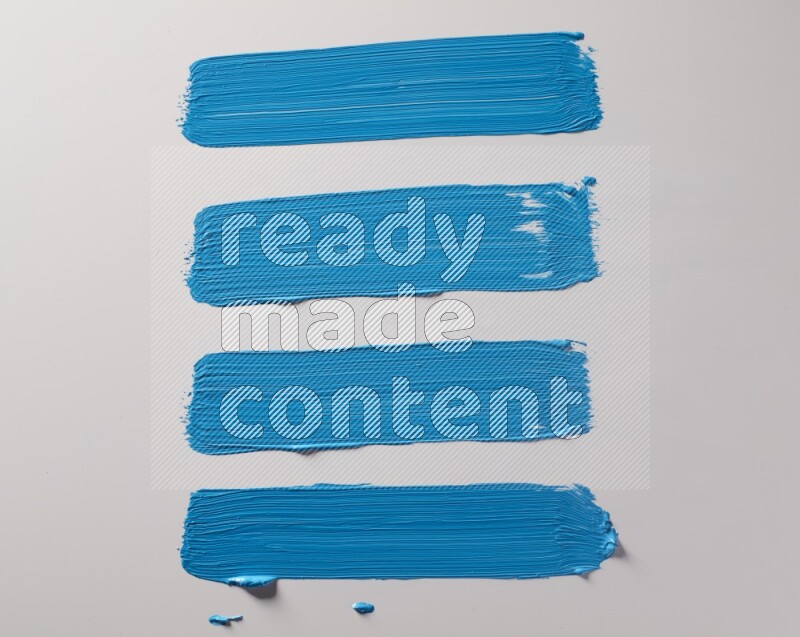 Multi blue straight brush strokes in different shapes on a white background