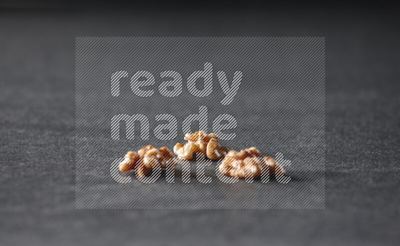 3 walnuts on a black background in different angles
