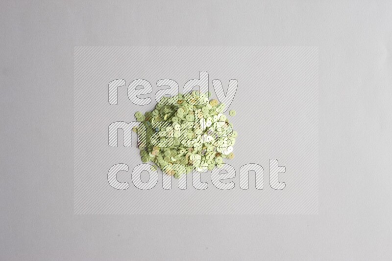 Multicolored flat sequins on grey background