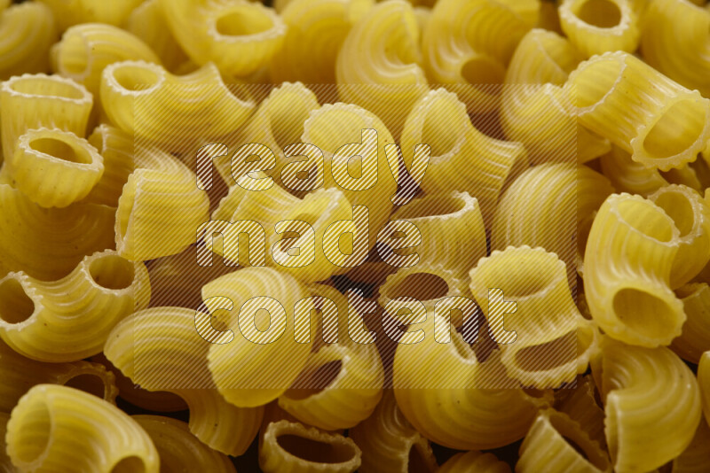 Elbow pasta on grey background