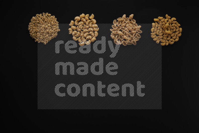 Different pasta types in 4 bunches on black background