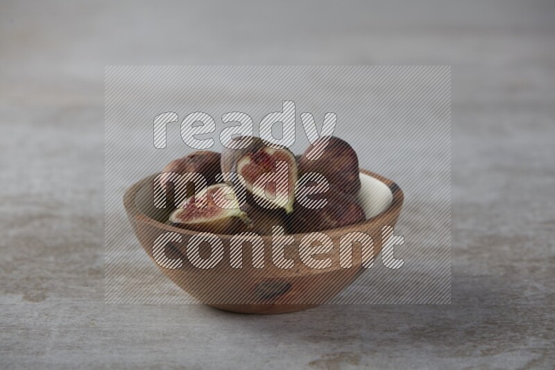 Fresh figs in a bowl on textured grey background