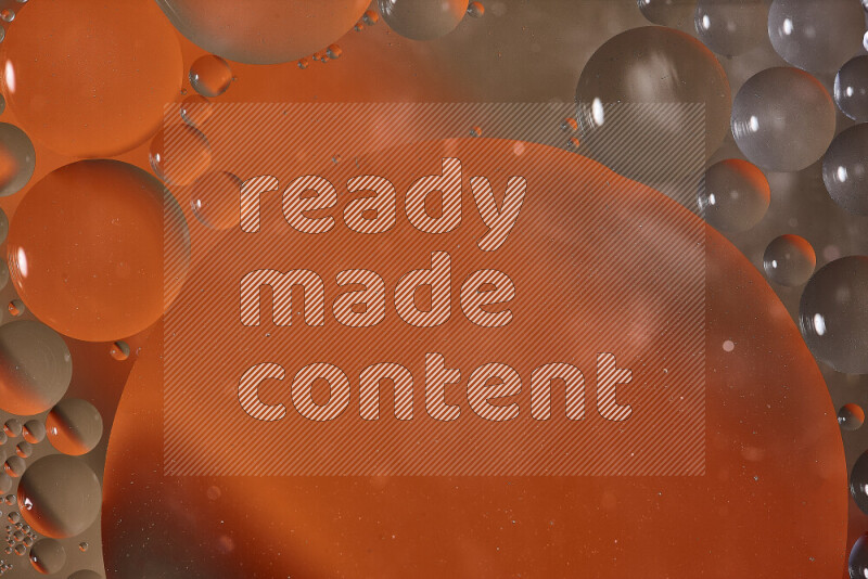 Close-ups of abstract oil bubbles on water surface in shades of orange and brown