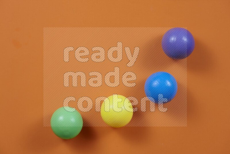 Multicolored plastic balls on different colored backgrounds (kids toys)