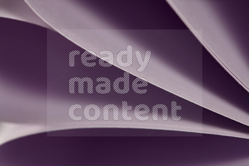 An abstract art showing purple paper sheets arranged in an overlapping curves