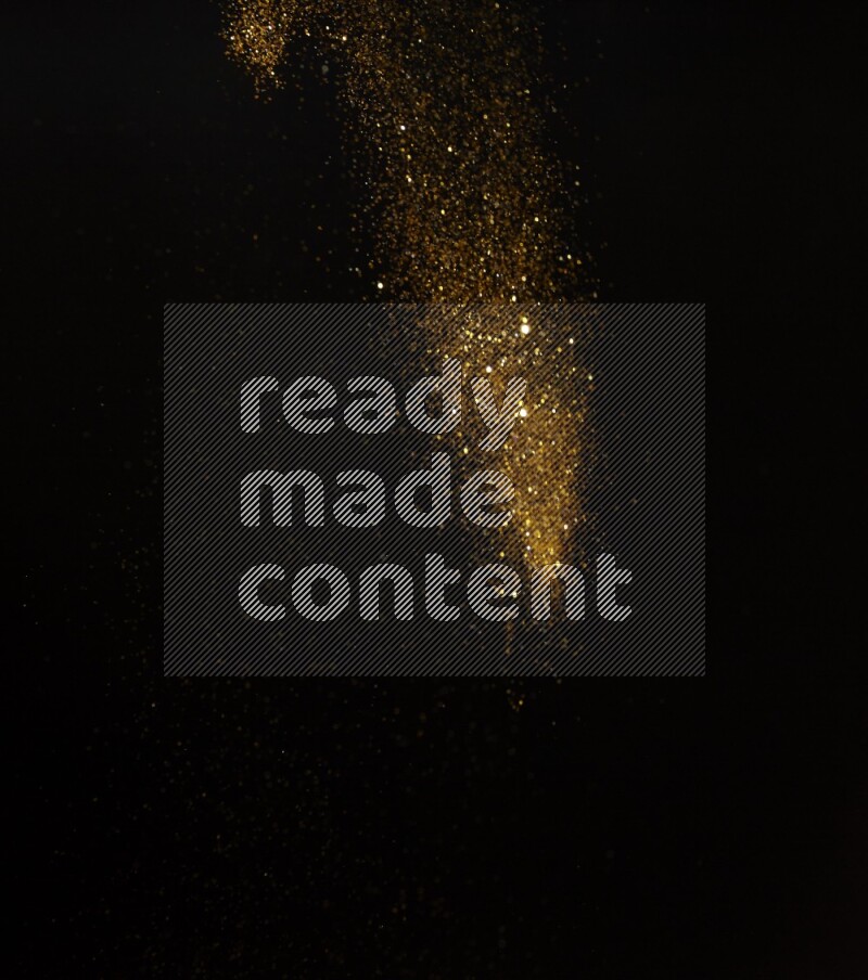 Gold glitter powder isolated on black background