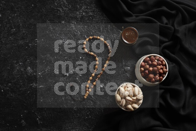 Nuts in pottery bowls with coffee in a dark setup