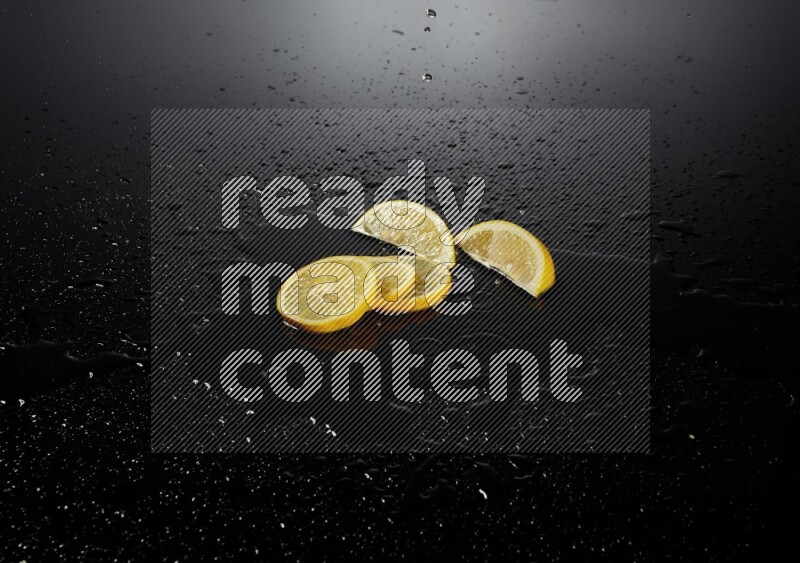 Lemon slices with water drops, and droplets on black background