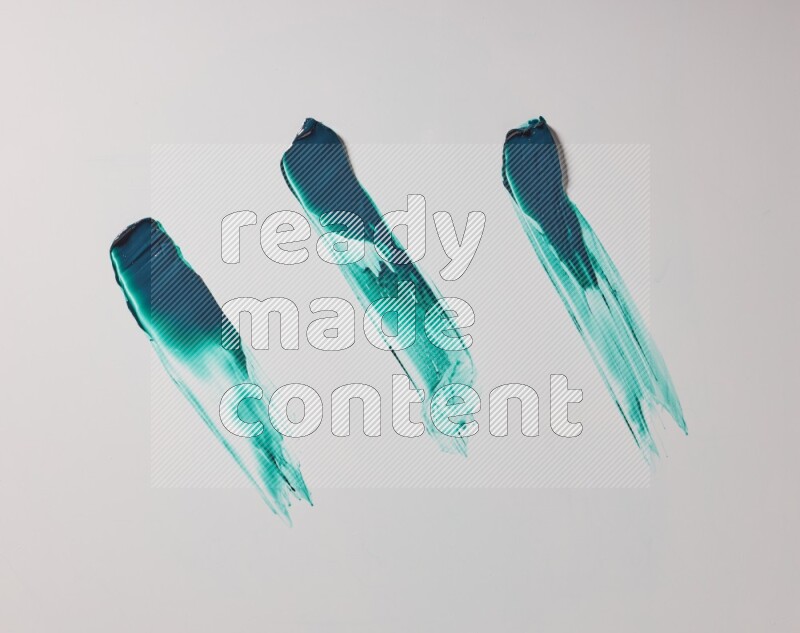 Turquoise painting knife strokes on white background