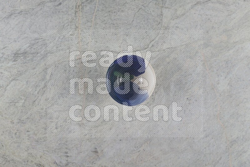 A multicolored pottery Bowl on grey marble background