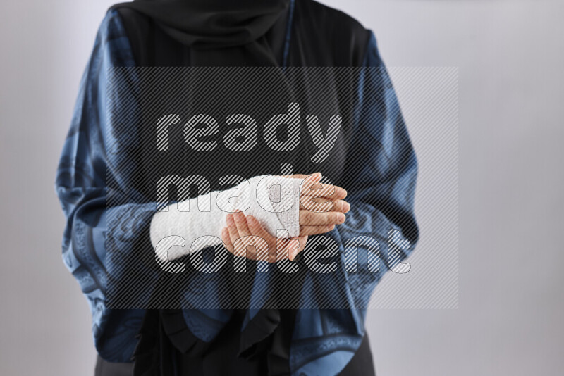 Woman with a bandaged hand and arm sling