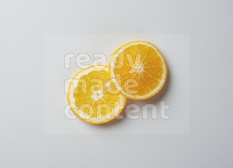 Two orange slices on white background