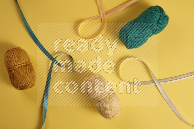 A green collection of sewing and tailoring tools arranged on a yellow background